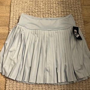 This pleated tennis skirt is new with tags! Its in a girls large